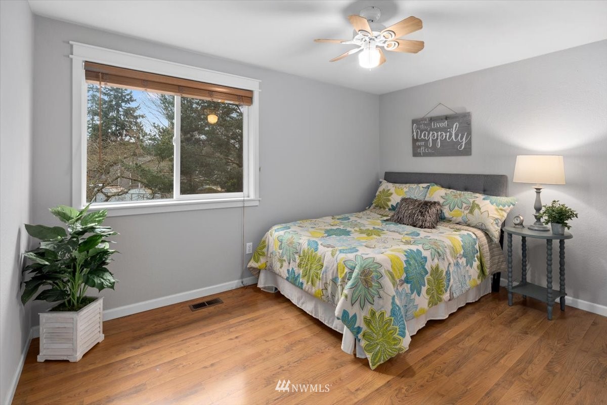 1723 225th Street Southeast Bothell, WA 98021 - Photo 14 of 40 a bed sitting in a bedroom next to a window
