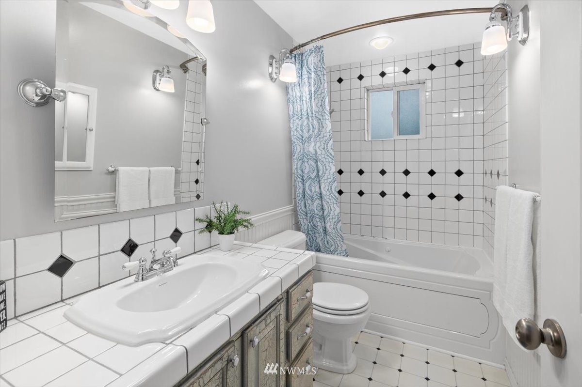 1723 225th Street Southeast Bothell, WA 98021 - Photo 16 of 40 a bathroom with a sink toilet a shower and a mirror