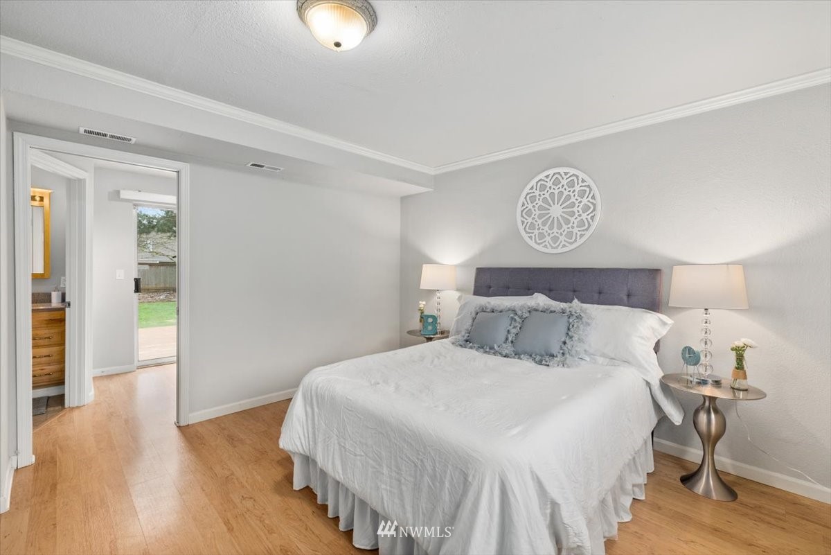 1723 225th Street Southeast Bothell, WA 98021 - Photo 18 of 40 a bedroom with a bed and a table in it