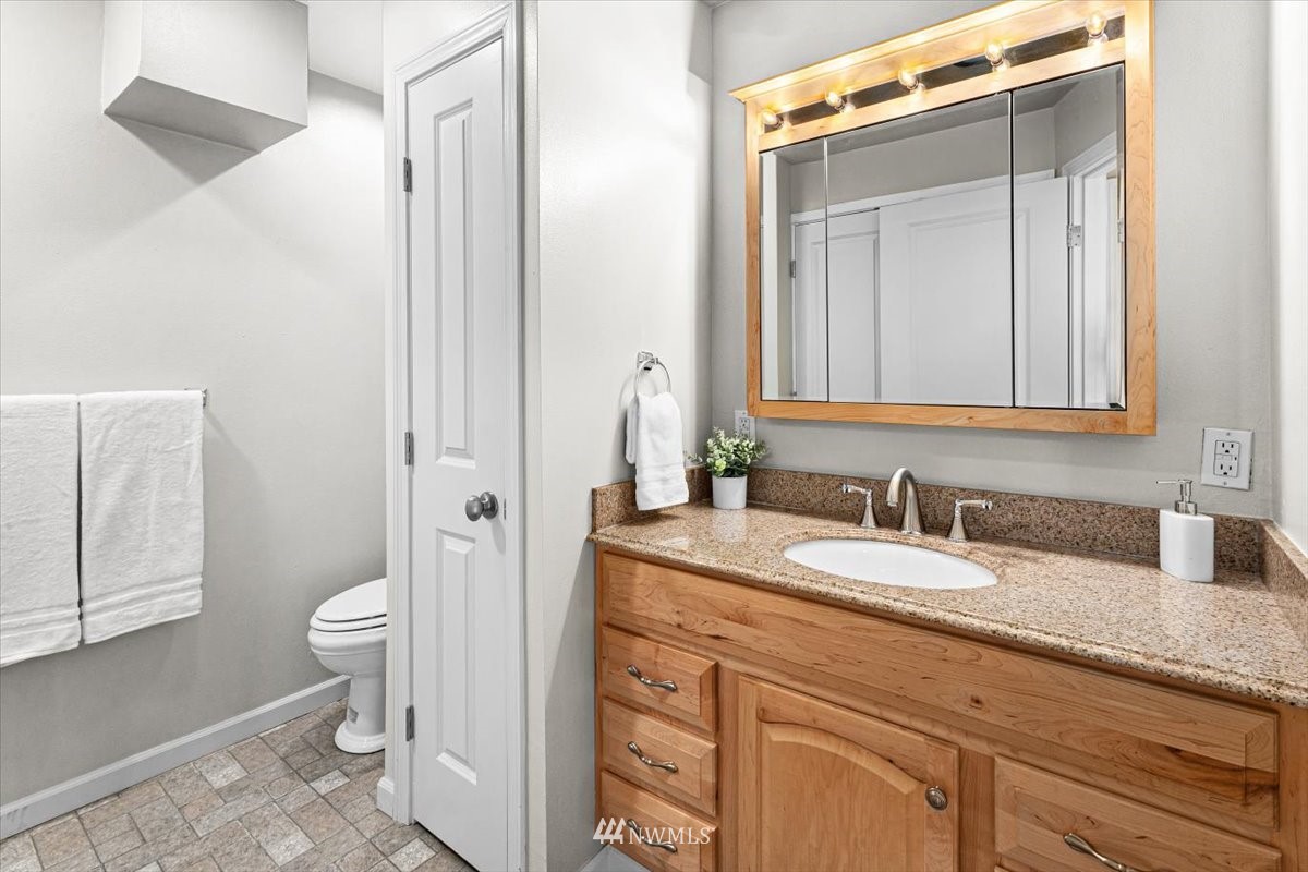 1723 225th Street Southeast Bothell, WA 98021 - Photo 20 of 40 a bathroom with a granite countertop sink mirror and a toilet