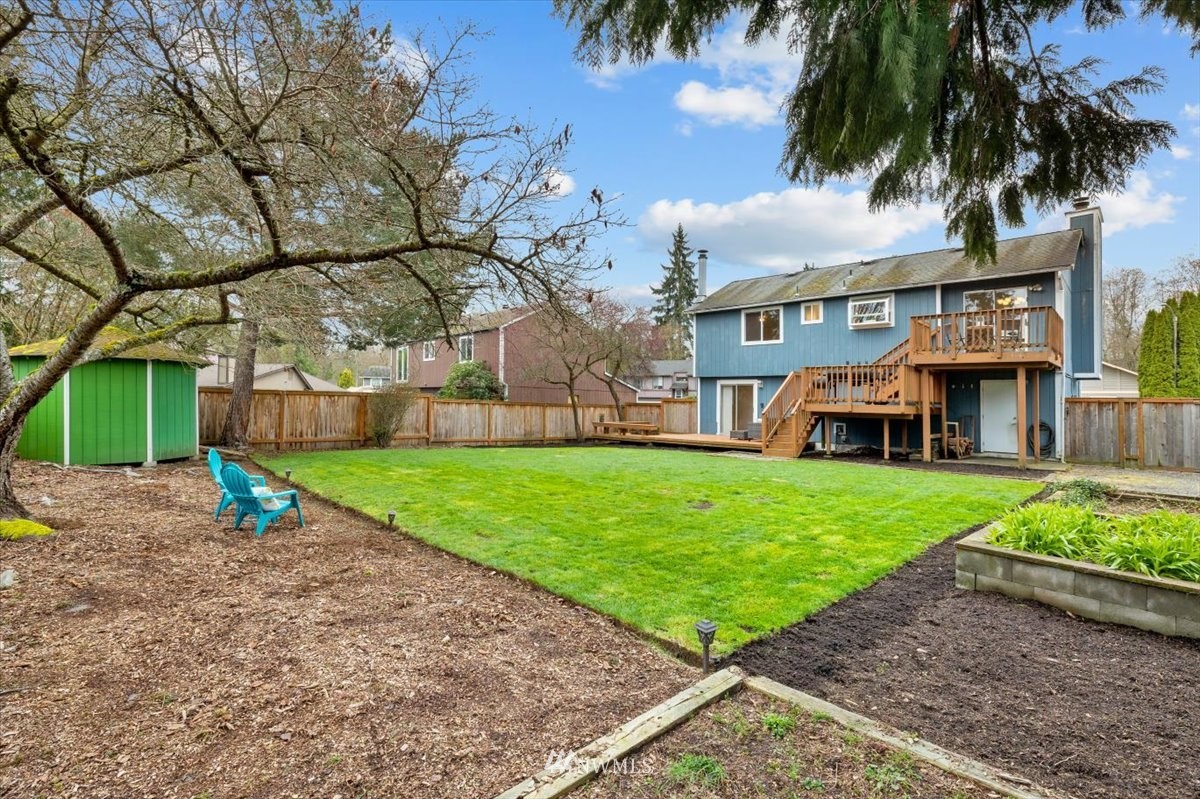 1723 225th Street Southeast Bothell, WA 98021 - Photo 32 of 40 a view of a house with a yard and palm trees