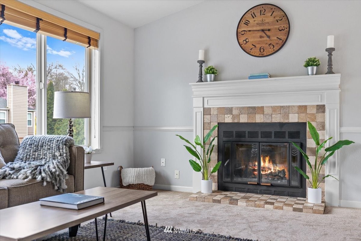 1723 225th Street Southeast Bothell, WA 98021 - Photo 4 of 40 a living room with furniture a clock and a fireplace