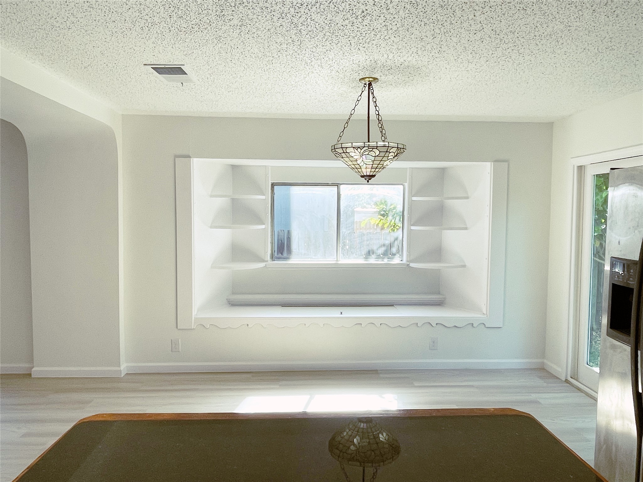 1103 Pike Path Round Rock, TX 78665 - Photo 12 of 36 The inviting dining room bathed in natural light, with the adjacent kitchen offering a seamless connection. The open layout enhances the sense of spaciousness and encourages effortless flow between cooking and dining spaces, creating an ideal setting for both everyday meals and special gatherings with family and friends.