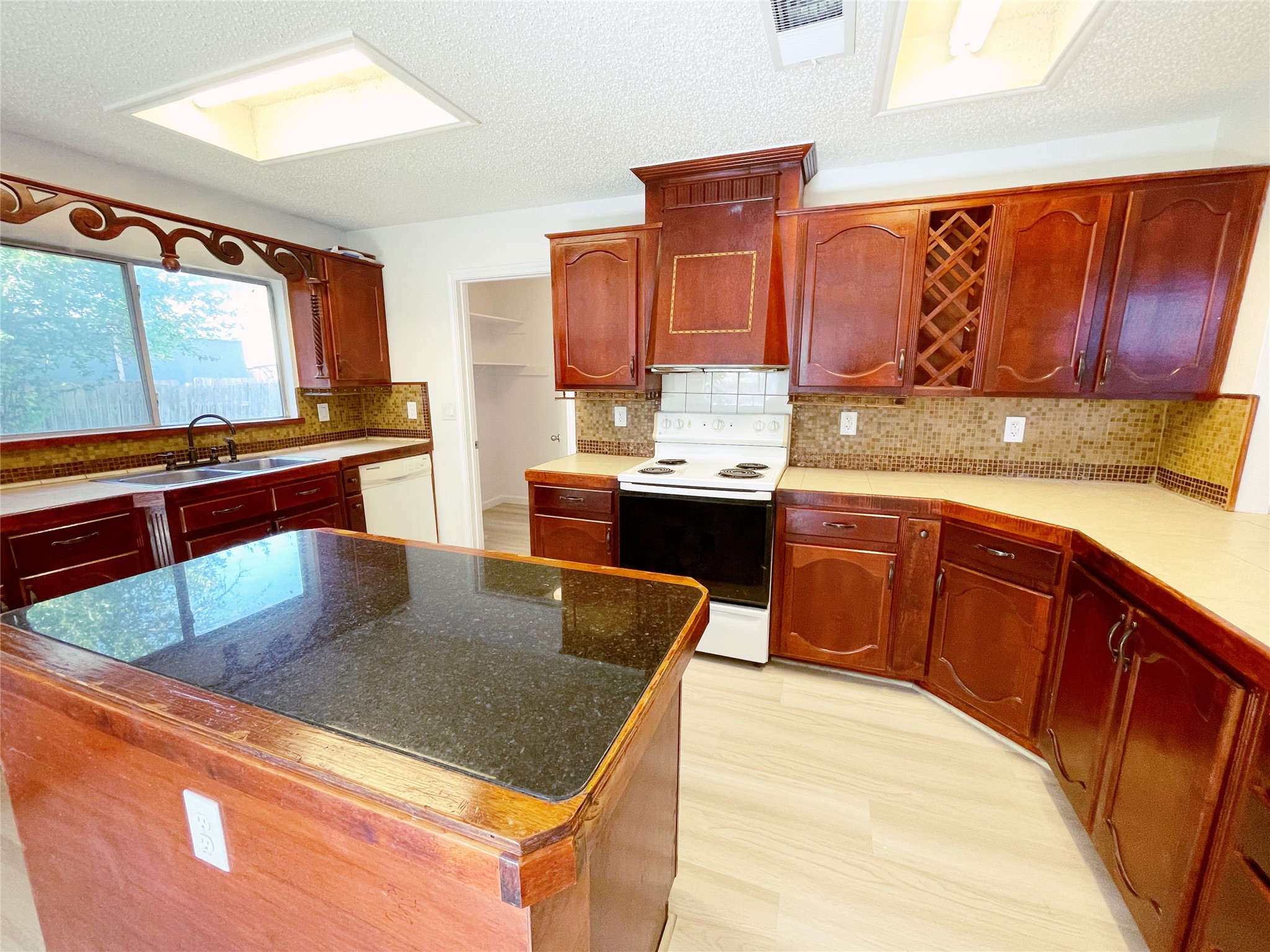 1103 Pike Path Round Rock, TX 78665 - Photo 15 of 36 With ample room to work and entertain, this kitchen promises not only delicious meals but also memorable moments shared with loved ones.