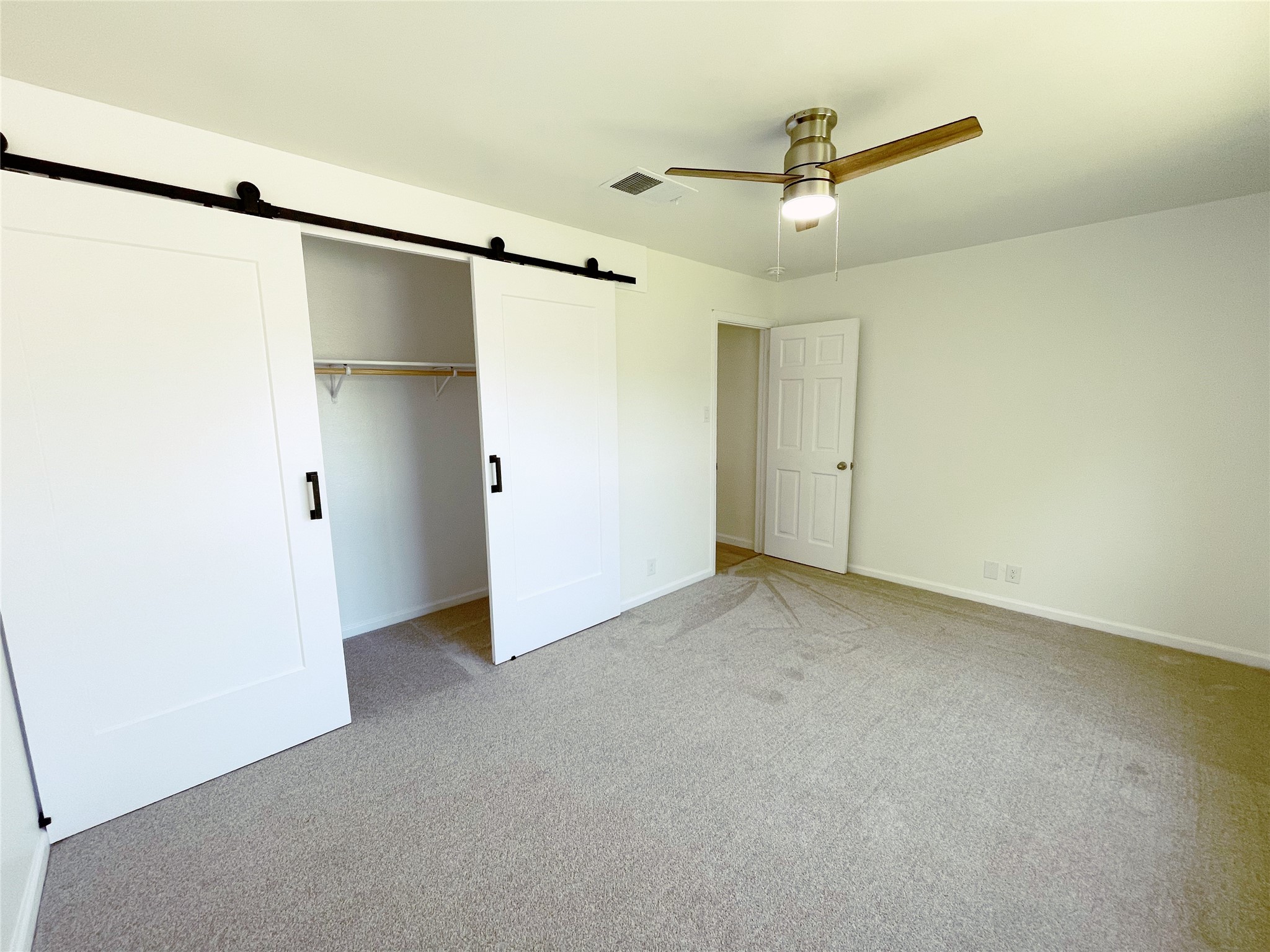 1103 Pike Path Round Rock, TX 78665 - Photo 24 of 36 This large closet offers ample storage for all your belongings, whether it's clothes, shoes, or extra bedding. The sliding doors not only save space but also add a modern touch to the room's aesthetic.