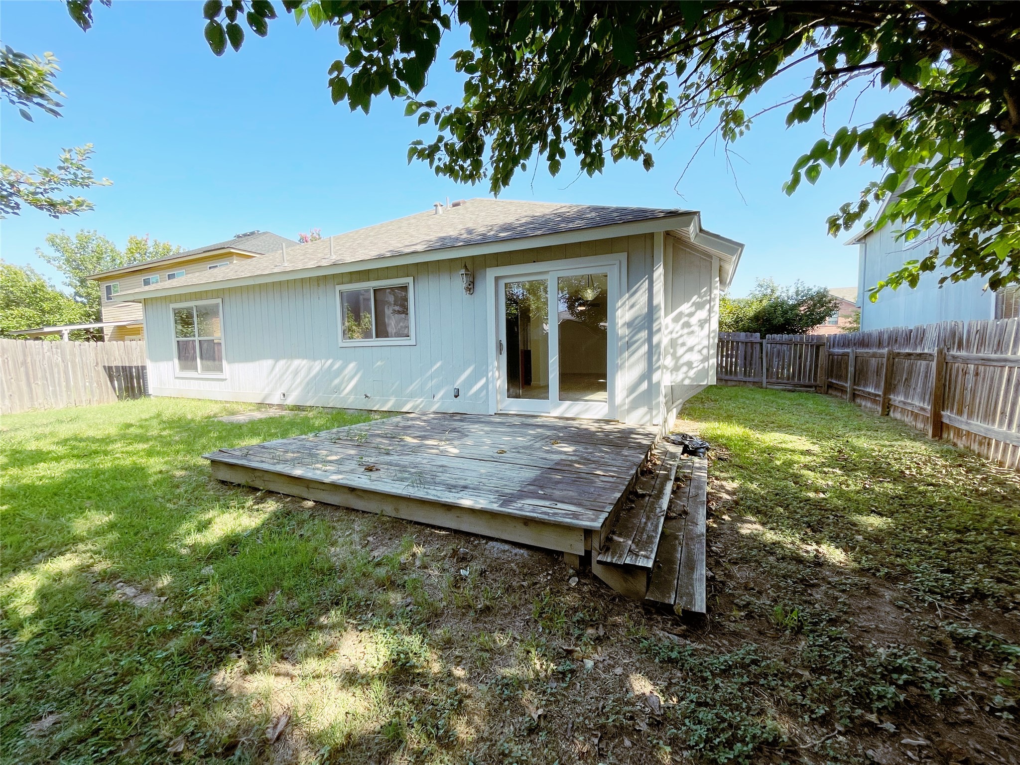 1103 Pike Path Round Rock, TX 78665 - Photo 36 of 36 Whether you're hosting gatherings, playing with pets, or simply enjoying the fresh air, the fenced backyard offers a peaceful haven right at home. The privacy and shade provided by the fence and surrounding trees ensure comfort and enjoyment, making it an ideal space for leisure and outdoor living.