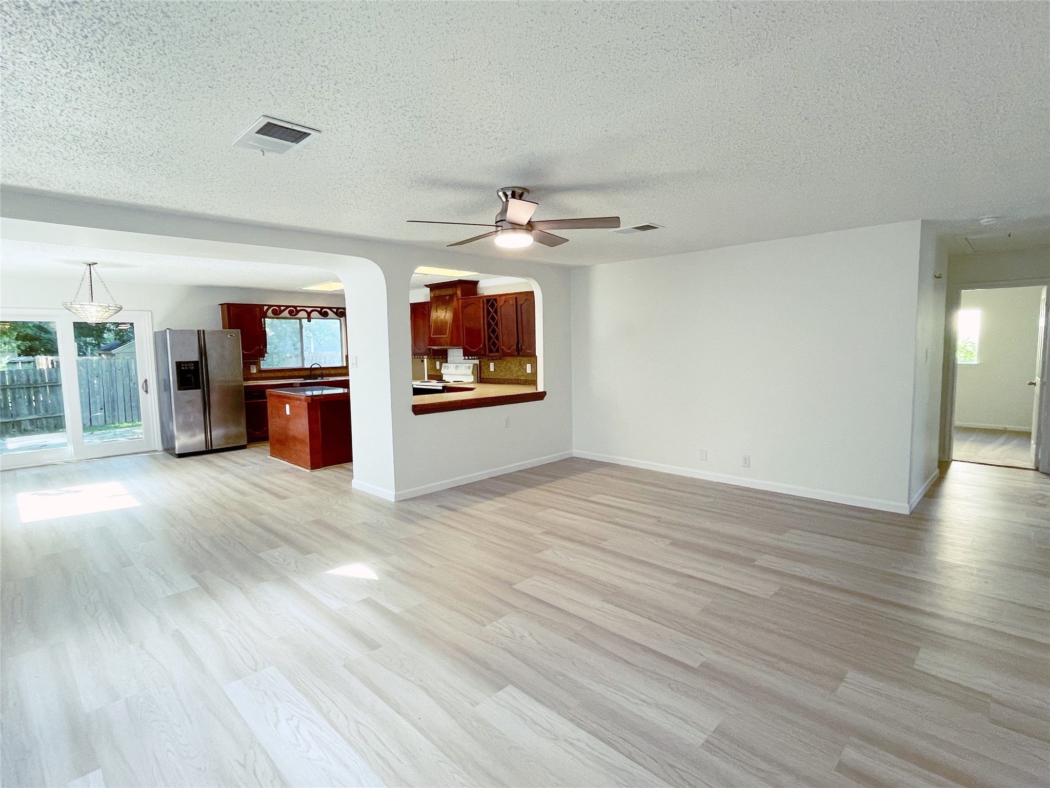 1103 Pike Path Round Rock, TX 78665 - Photo 6 of 36 Step into the inviting ambiance of this living room, where the open space and abundant natural light create a bright and welcoming atmosphere. The room's clean lines and neutral tones offer a versatile backdrop for personal style and relaxation, making it a perfect retreat for both quiet moments and lively gatherings.