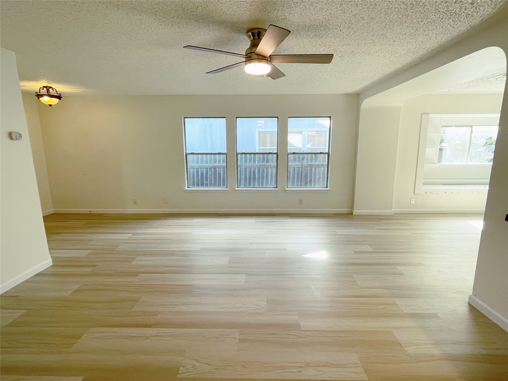 1103 Pike Path Round Rock, TX 78665 - Photo 8 of 36 Natural light enhances the room's warm tones, highlighting the cozy seating arrangement and elegant accents that make it a perfect space for relaxation and gatherings.