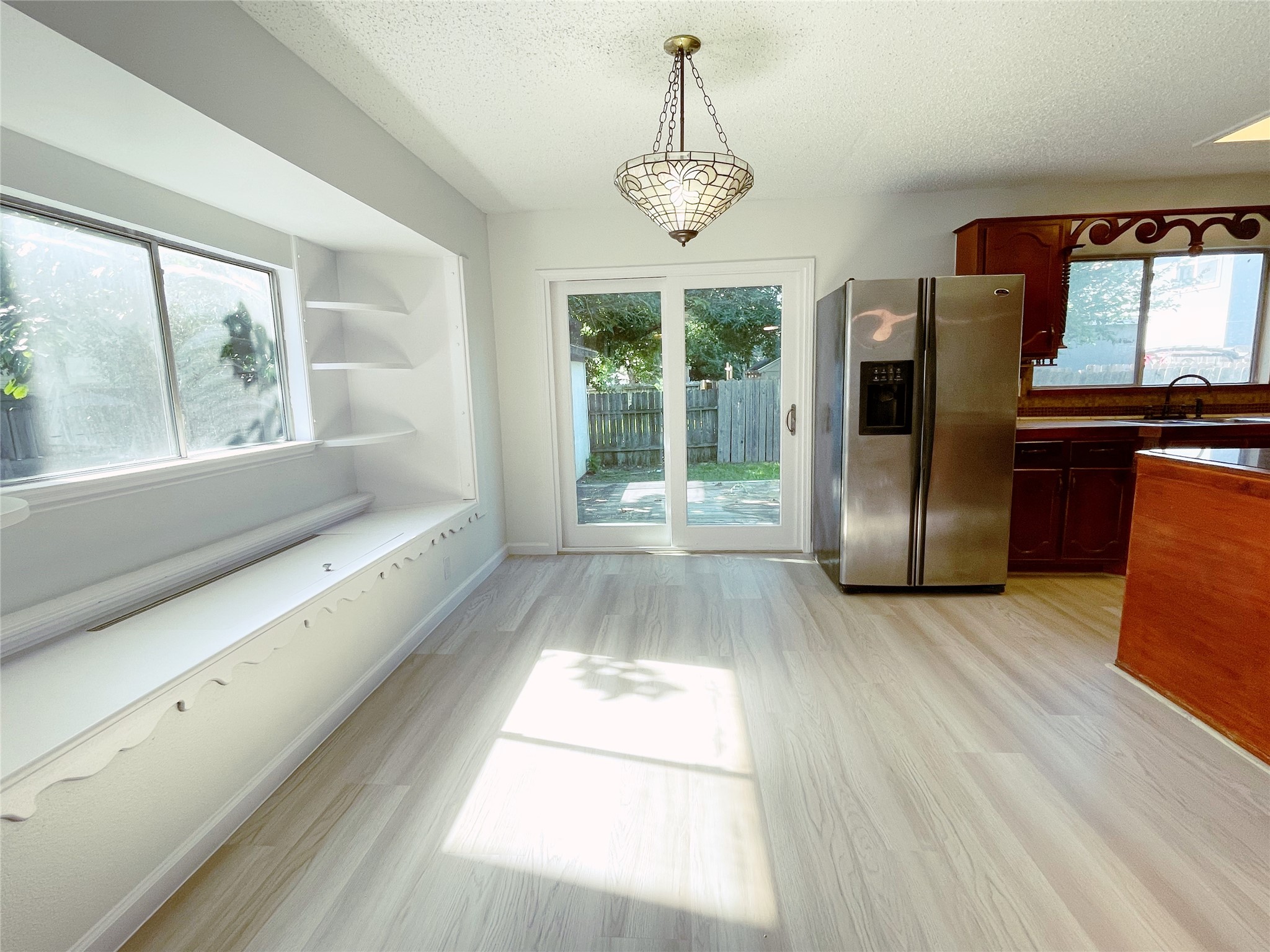 1103 Pike Path Round Rock, TX 78665 - Photo 10 of 36 Beautifully showcases the dining room, flooded with an abundance of natural light that enhances its inviting atmosphere. The sunlight illuminates the spacious layout, creating a bright and airy setting perfect for enjoying meals with family and friends.