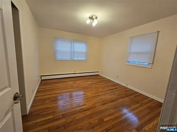 a view of room with wooden floor and staircase