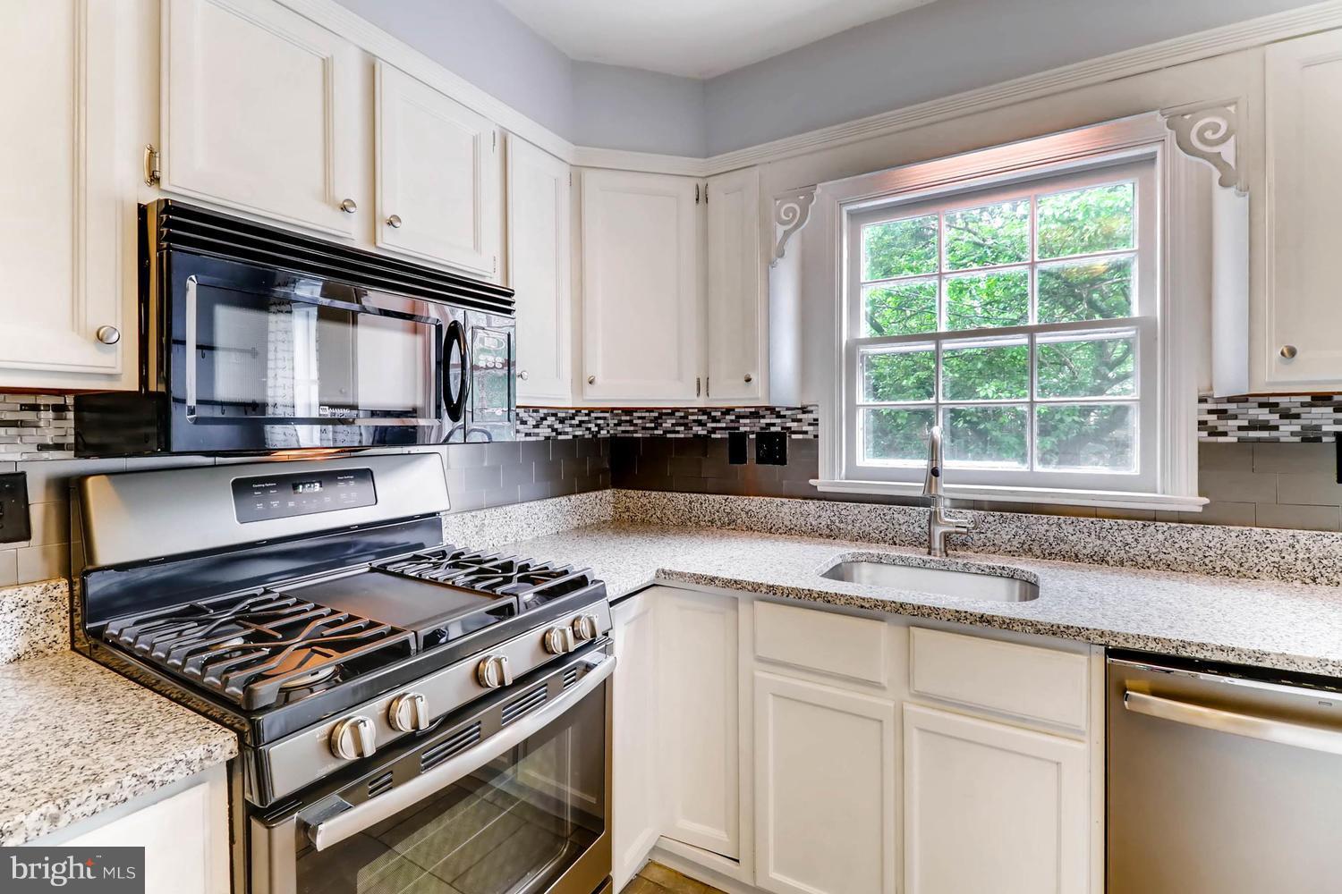 1863 Edgewood Road Towson, MD 21286 - Photo 14 of 30 a kitchen with granite countertop a stove sink and cabinets