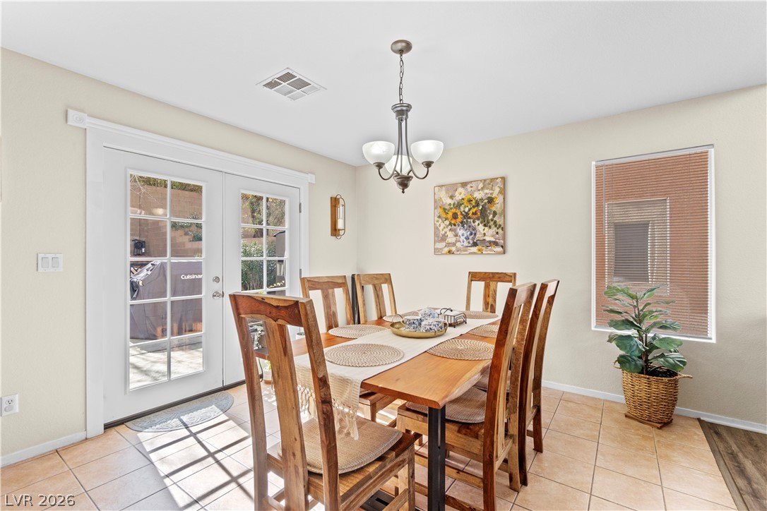 1419 Red Sunset Avenue Henderson, NV 89074 - Photo 10 of 35 Dining room featuring french doors, suspended lighting, and light tile patterned flooring
