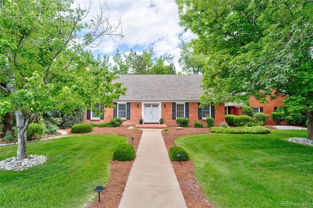 a front view of a house with yard patio and green space