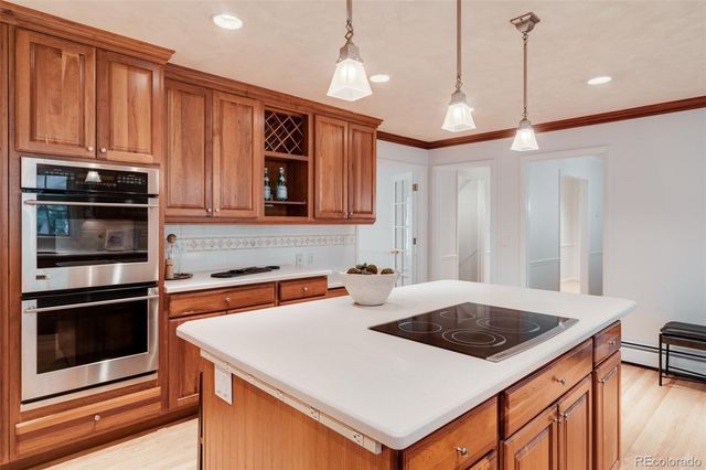 a kitchen with a stove a sink and a refrigerator