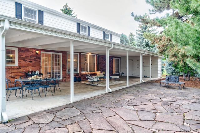 a view of a house with backyard porch and sitting area