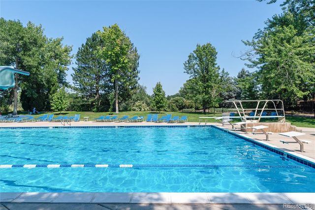 a view of a swimming pool with a yard