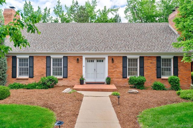 a front view of a house with a yard and outdoor seating
