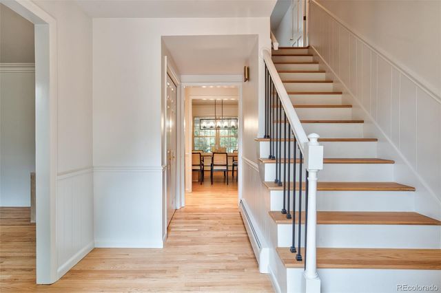 a view of entryway and hall with wooden floor