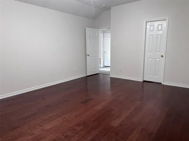 a view of wooden floor and windows in a room
