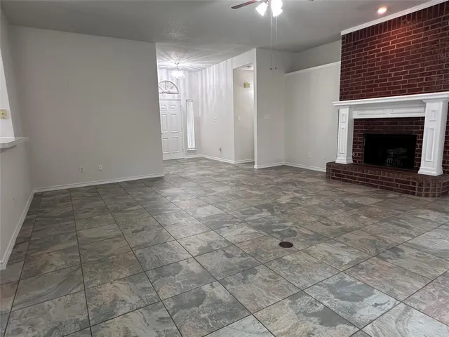a view of an empty room with a fireplace
