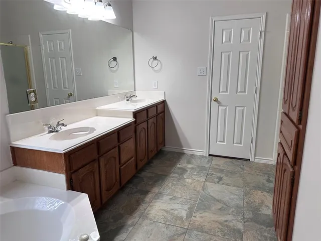 a bathroom with a double vanity sink and a mirror