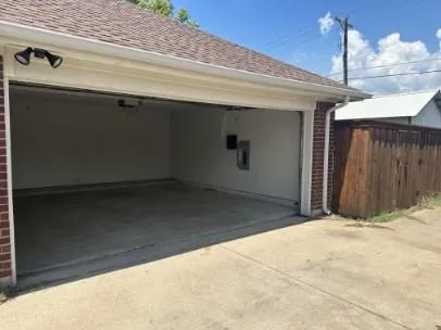a view of backyard with a small cabin and wooden fencing
