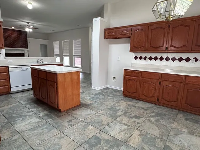 a kitchen with stainless steel appliances granite countertop a stove and a sink