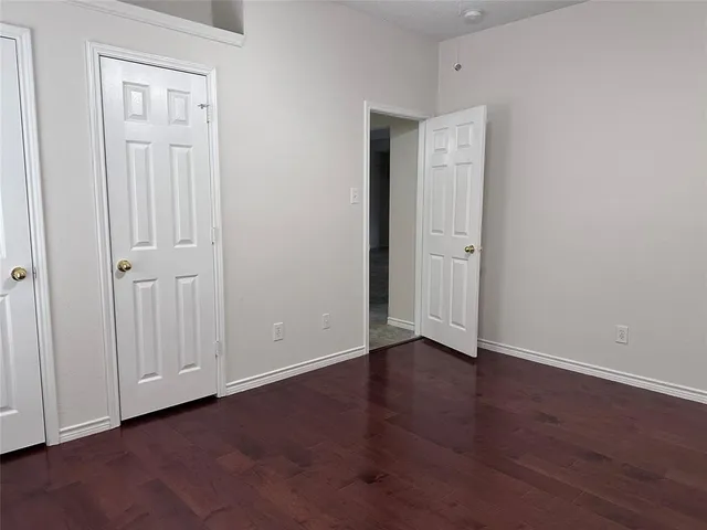 a view of an empty room with closet area