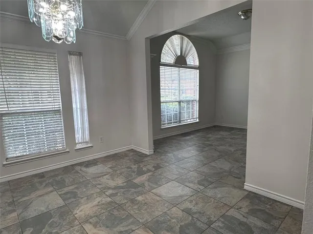 an empty room with windows and entrance