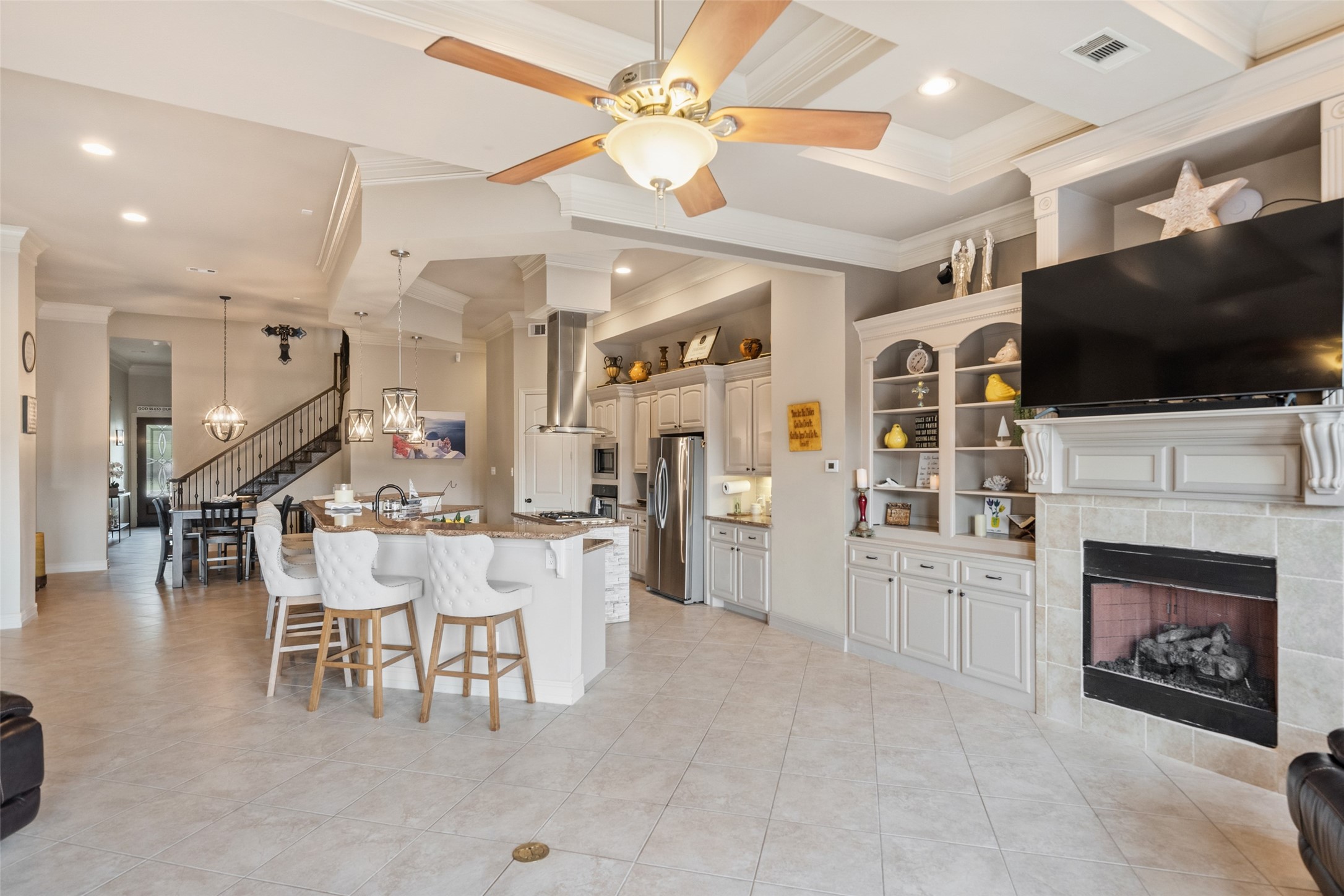 255 Capetown Way Conroe, TX 77356 - Photo 6 of 30 a living room with furniture a flat screen tv and a fireplace
