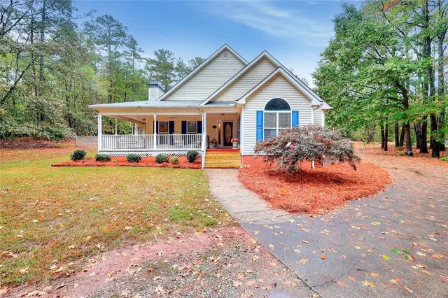 a front view of a house with a yard porch and sitting area