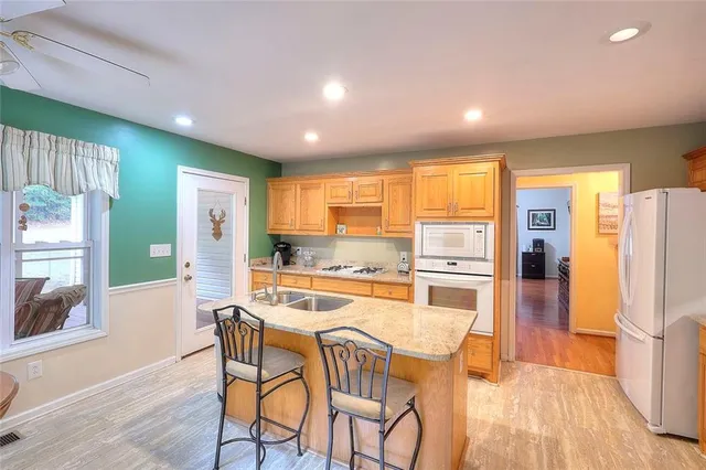 a kitchen with sink and view of living room