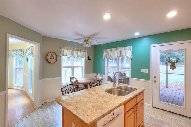 a kitchen with stainless steel appliances granite countertop a refrigerator a stove and a sink with granite countertops