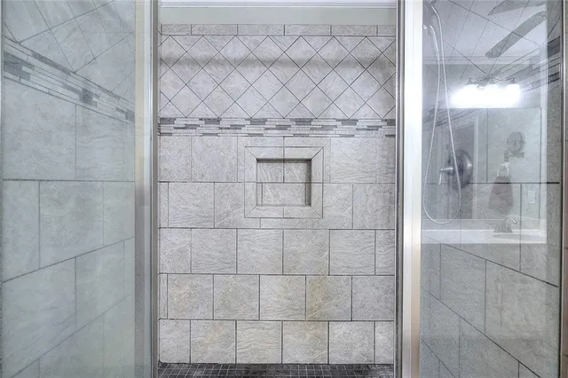 a bathroom with a granite countertop toilet sink and mirror