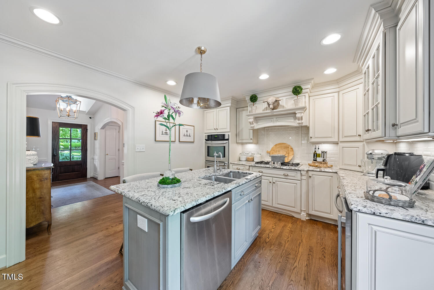 2421 Tyson Street Raleigh, NC 27612 - Photo 13 of 61 a kitchen with granite countertop a sink stove and cabinets