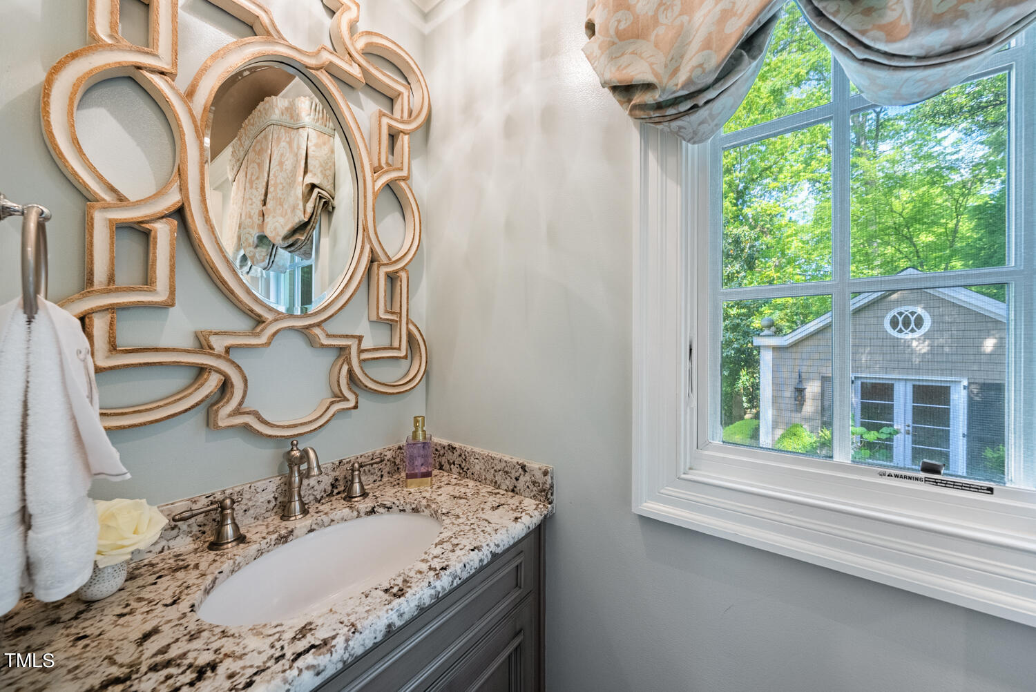 2421 Tyson Street Raleigh, NC 27612 - Photo 21 of 61 a bathroom with a granite countertop sink and a mirror