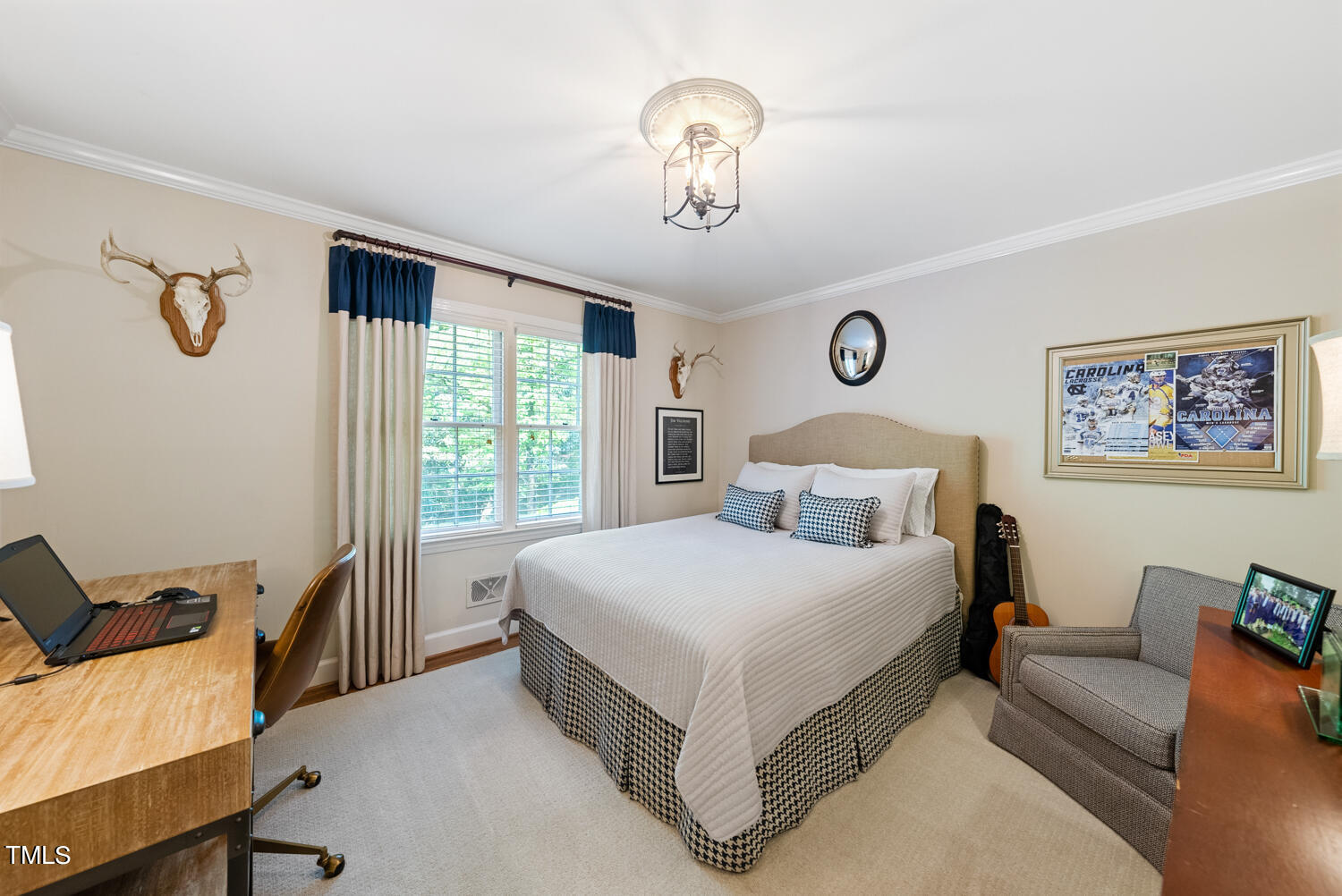 2421 Tyson Street Raleigh, NC 27612 - Photo 24 of 61 a spacious bedroom with a bed and a chandelier