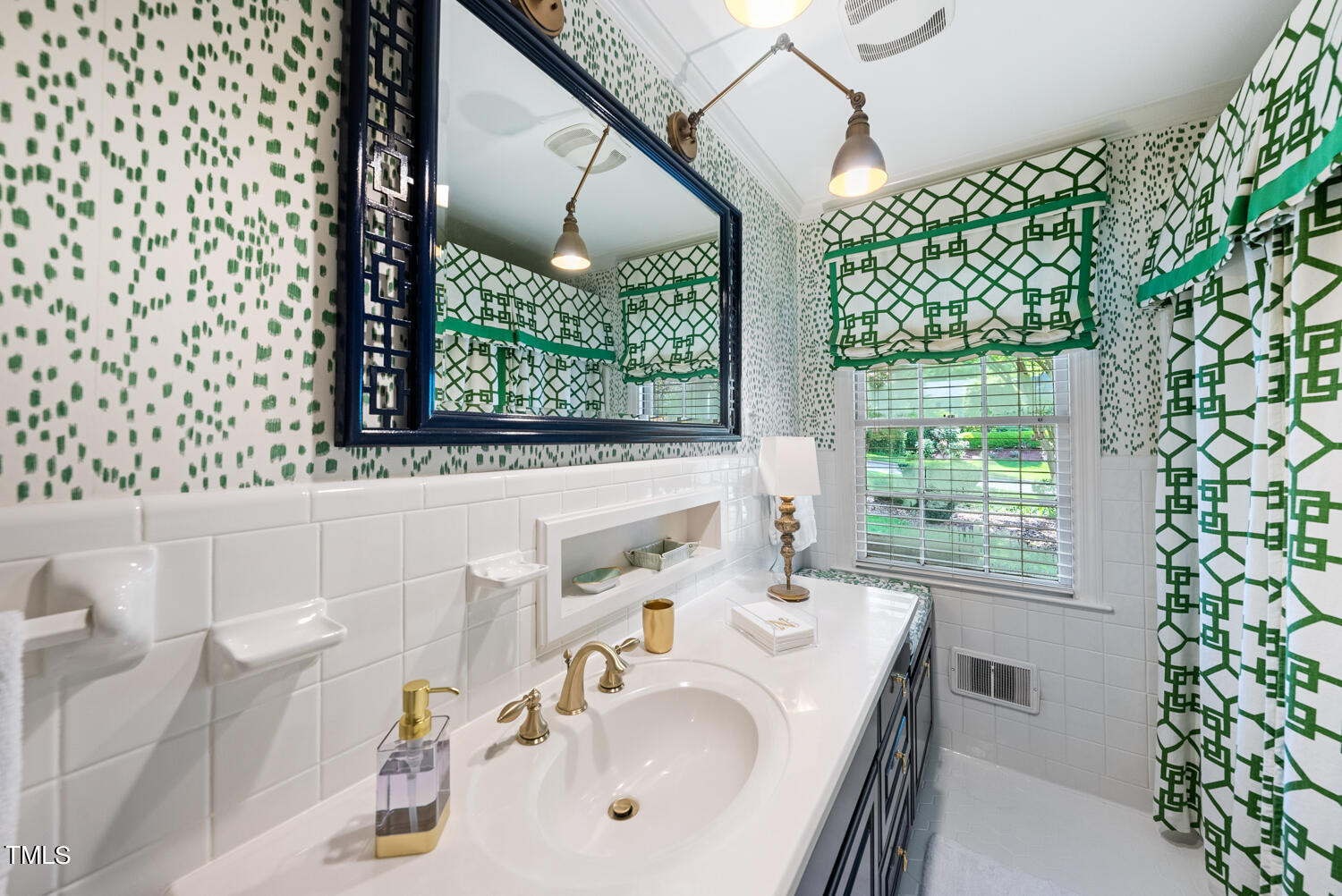 2421 Tyson Street Raleigh, NC 27612 - Photo 27 of 61 a bathroom with a sink and a large mirror