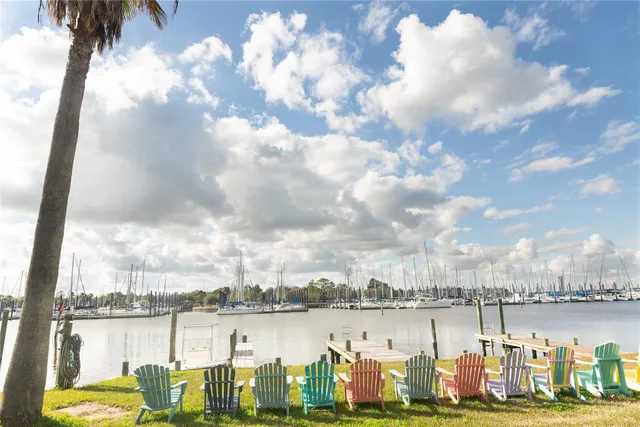 a view of a swimming pool with an outdoor seating and a lake view