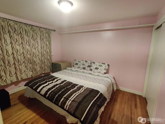 a bedroom with a bed and a window