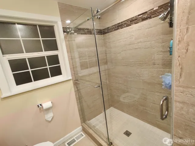 a bathroom with a shower and bathtub