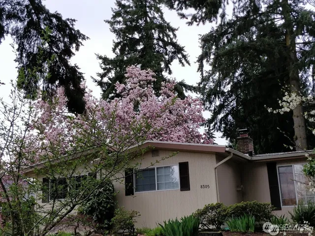a white house with tree in the background
