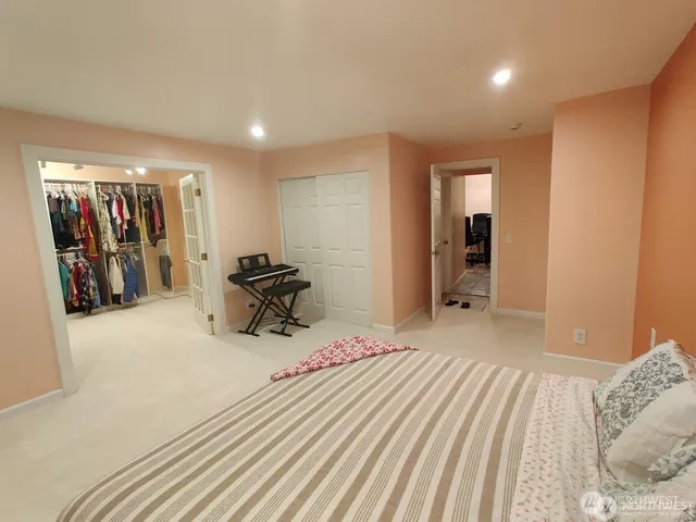 a bedroom with a bed and a large mirror