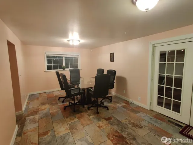 a view of a workspace with furniture and a window