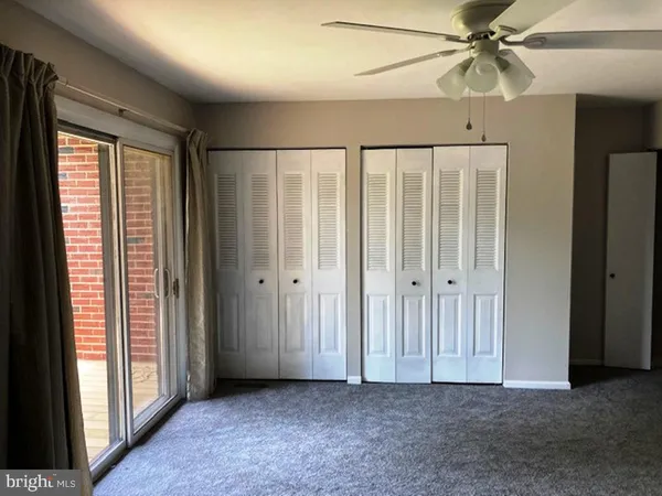 a view of a room with an empty space and wooden floor