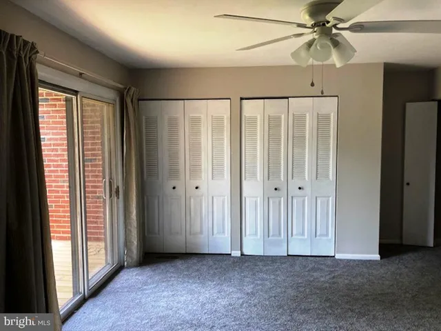 a view of a room with an empty space and wooden floor