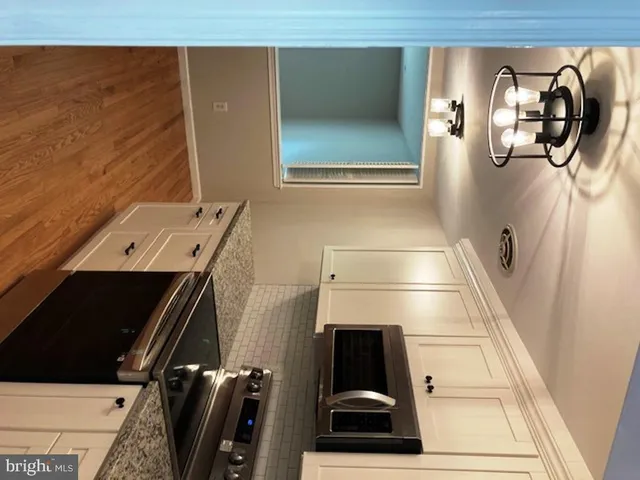 a view of room with window and wooden floor