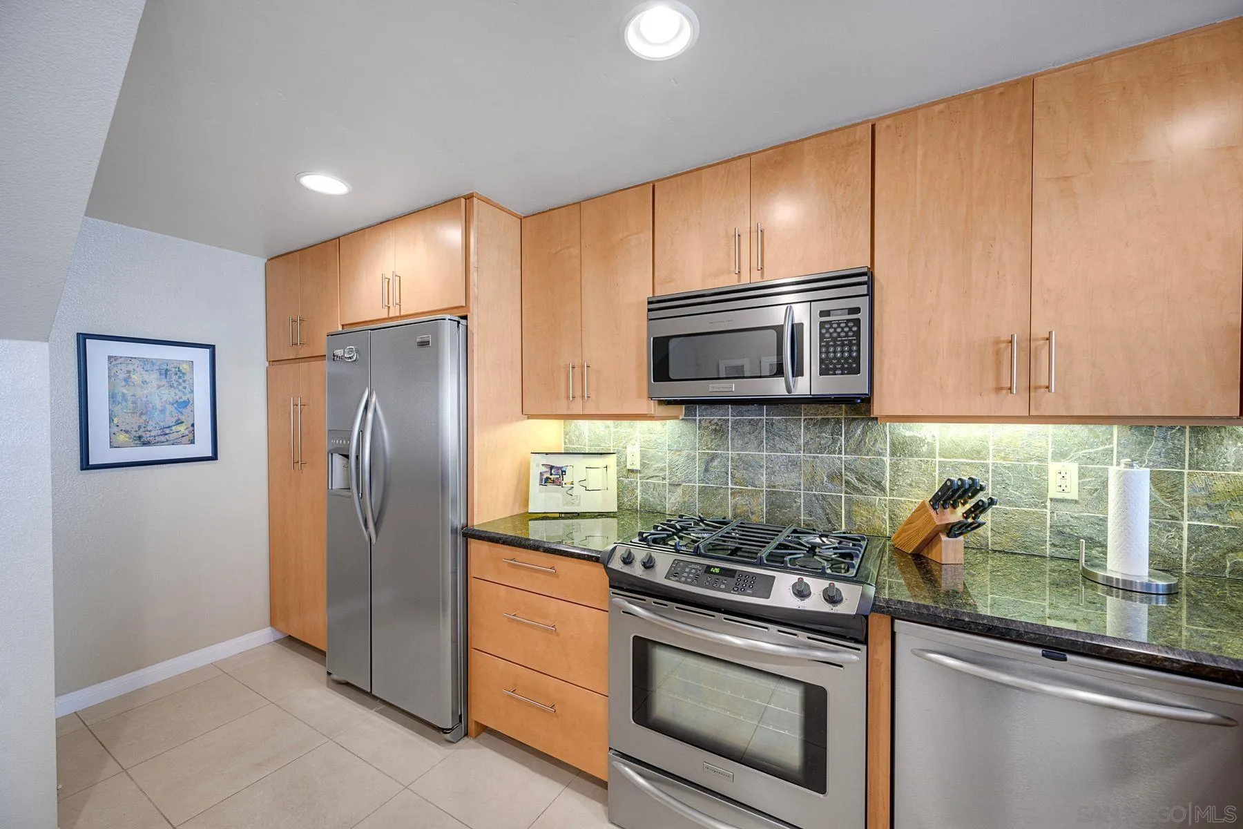 3467 Reynard Way, Unit A San Diego, CA 92103 - Photo 13 of 29 a kitchen with stainless steel appliances granite countertop a refrigerator and a stove top oven
