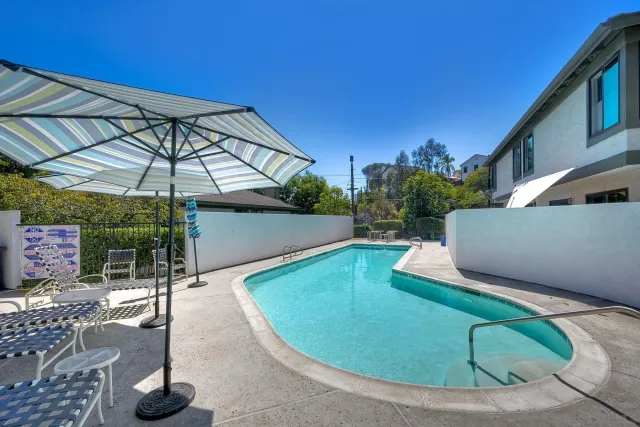 a backyard of a house with table and chairs