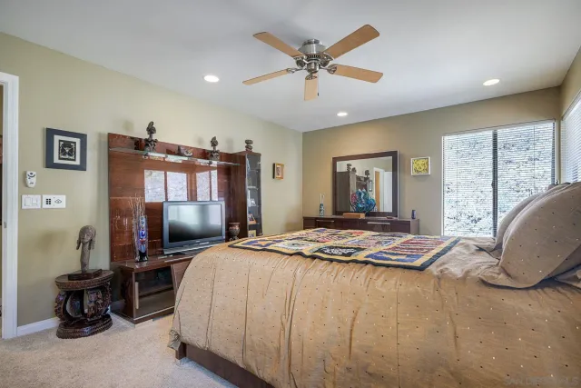 a spacious bathroom with a granite countertop sink toilet a large mirror and shower